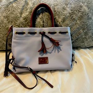 Dooney & Bourke purse with both handles and long strap.